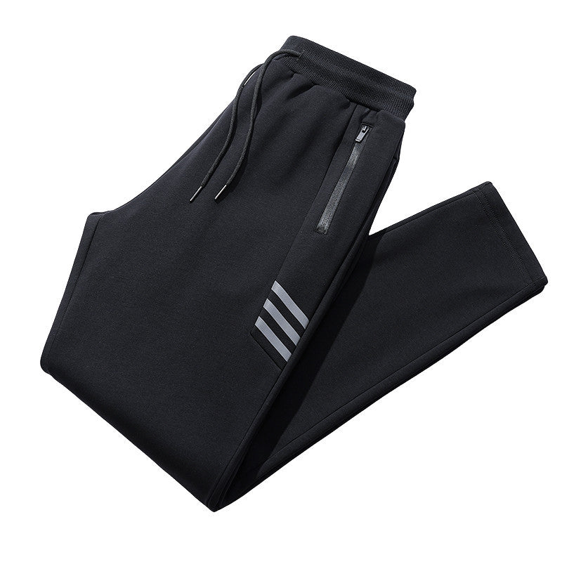 Black athletic jogger pants with elastic waistband, drawstrings, zippered pocket, and three reflective stripes