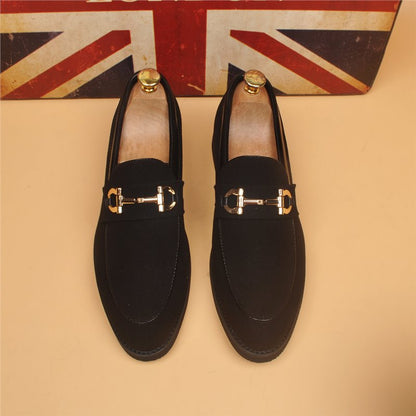 Black suede men's loafers with gold horsebit detail, wooden shoe trees, Union Jack background