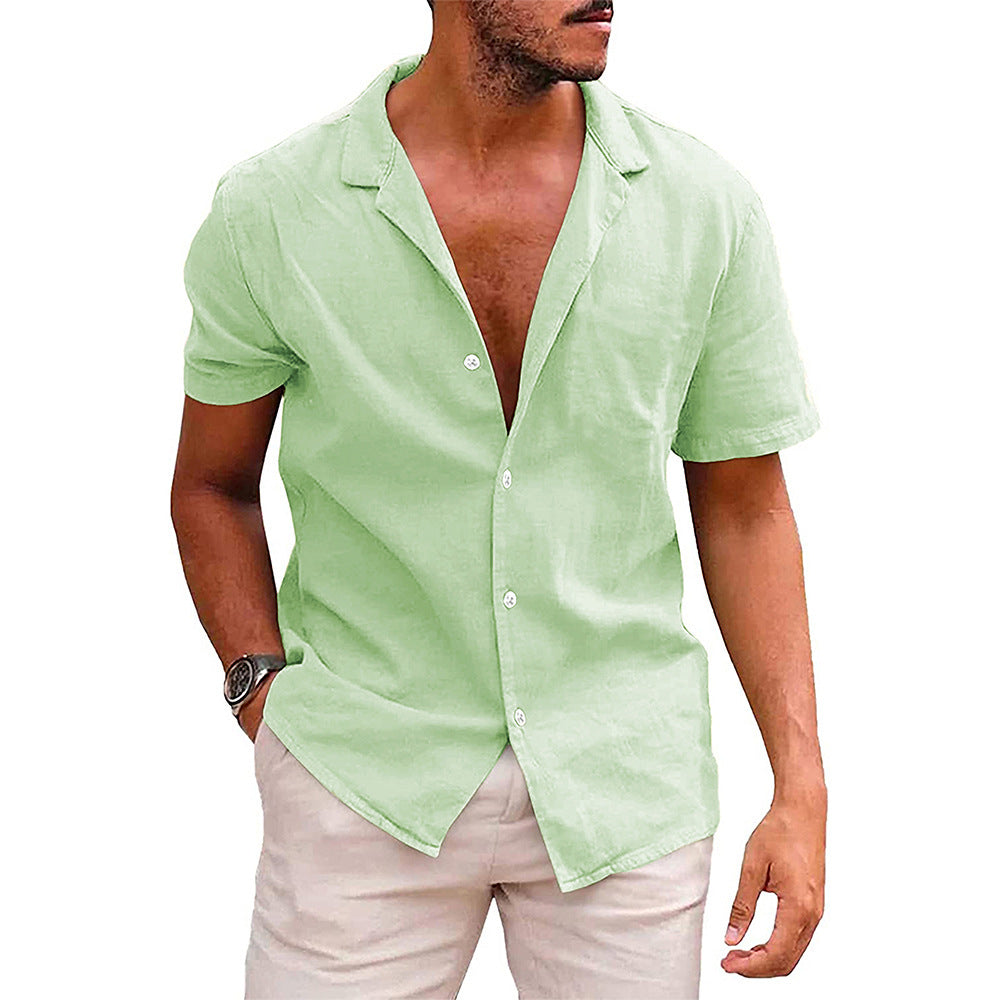 Man wearing a light green short-sleeve button-up casual shirt with beige pants