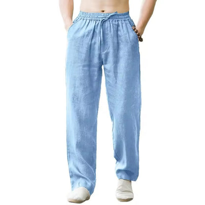 Men's light blue linen pants with elastic waistband and drawstring, styled with bare torso and barefoot