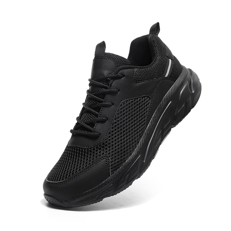 Black athletic sneaker with mesh upper, cushioned sole, and pull tab on white background
