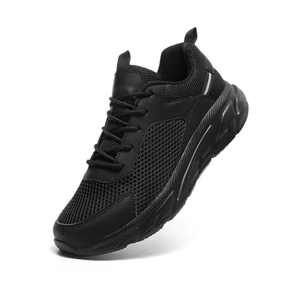 Black athletic sneaker with mesh upper, cushioned sole, and pull tab on white background