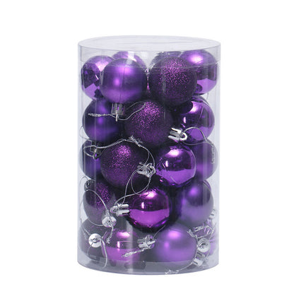 Clear cylindrical container filled with assorted shiny and glittery purple Christmas ornaments