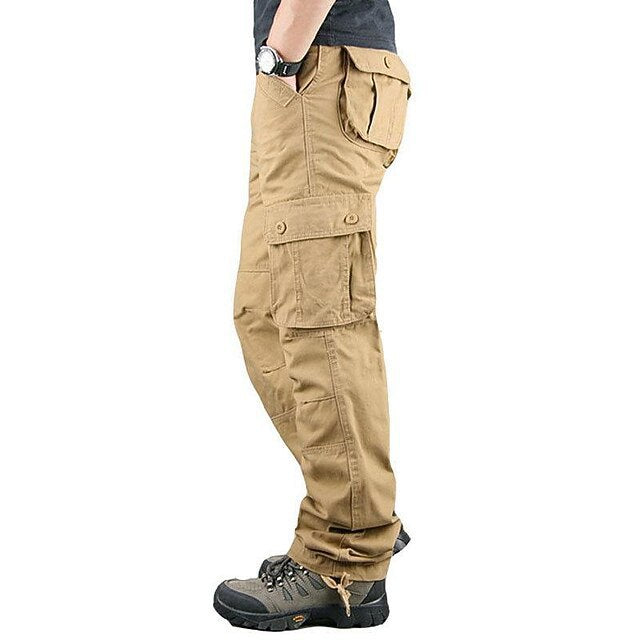 side view of tan cargo pants with multiple pockets worn with hiking shoes and black shirt
