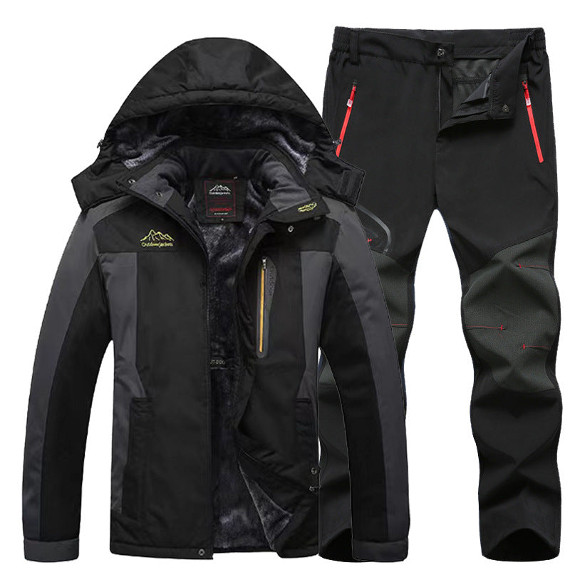 Black and gray outdoor winter jacket with hood and fleece lining alongside matching black hiking pants with red zipper details