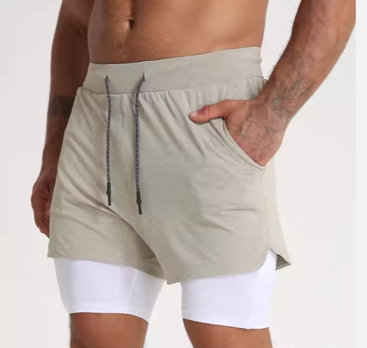 Men's beige dual-layer athletic shorts with white inner compression layer and side pockets
