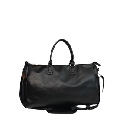 Black leather duffel bag with double handles and detachable shoulder strap on white background