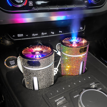 Car interior with two rhinestone-covered portable air purifiers emitting colored light and mist