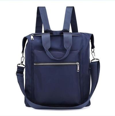 Navy blue waterproof backpack with front zipper pocket, adjustable straps, and detachable shoulder strap