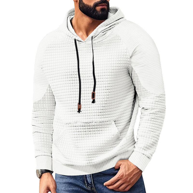 Man wearing white textured quilted hoodie with black drawstrings and front pocket