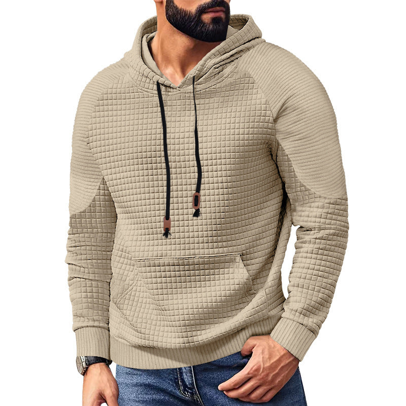 Man wearing beige textured waffle knit hoodie with black drawstrings and front pocket