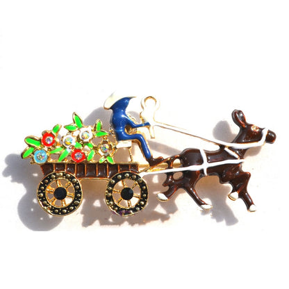 Vintage enamel brooch depicting a blue-clad driver on a flower-filled cart pulled by a brown dog