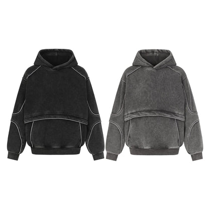 Two oversized hoodies in black and grey with exposed seam details and a layered cropped design