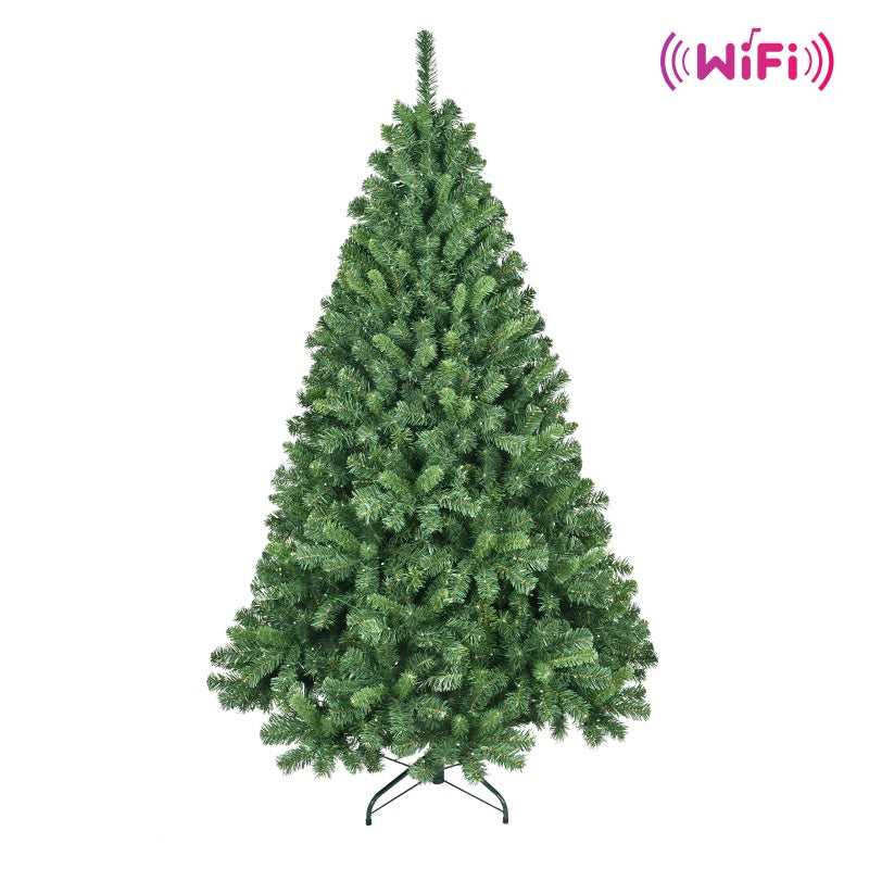 Artificial green Christmas tree with dense branches and metal stand on white background