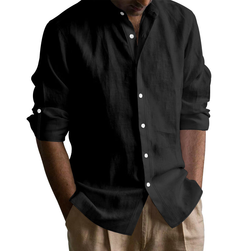 Man wearing casual black button-up shirt with rolled sleeves and beige pants