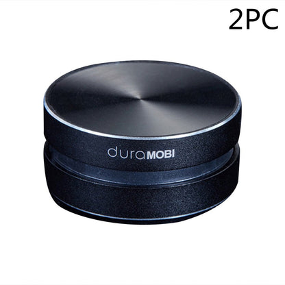 Two black circular duramobi magnetic phone holders with silver tops for dashboards