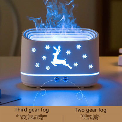 White humidifier with glowing reindeer and snowflakes design emitting blue mist on a table