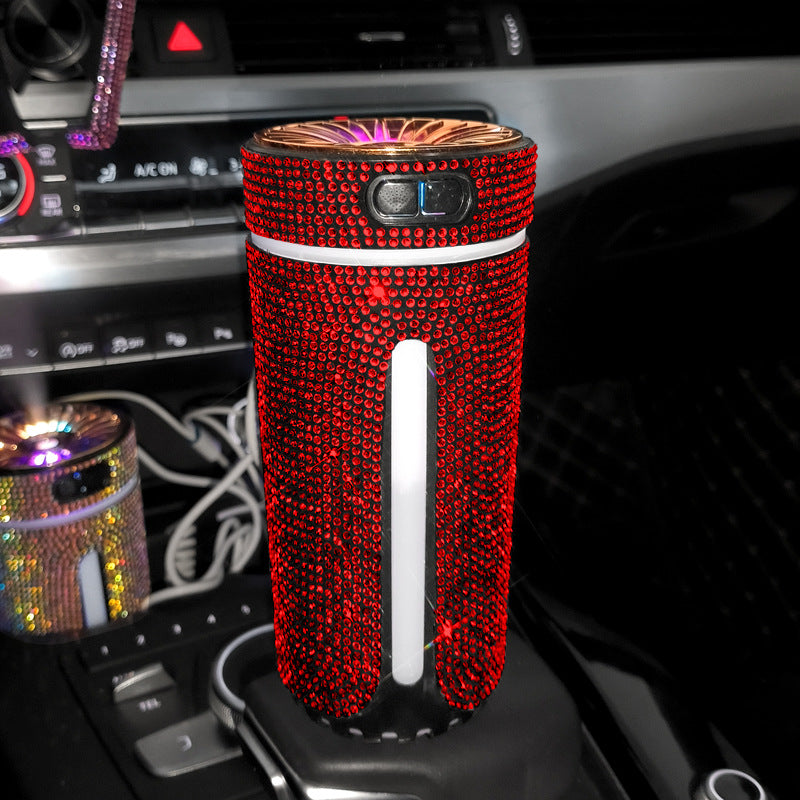Red rhinestone-covered portable air purifier in car cup holder with dashboard controls