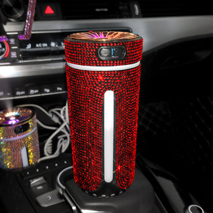 Red rhinestone-covered portable air purifier in car cup holder with dashboard controls