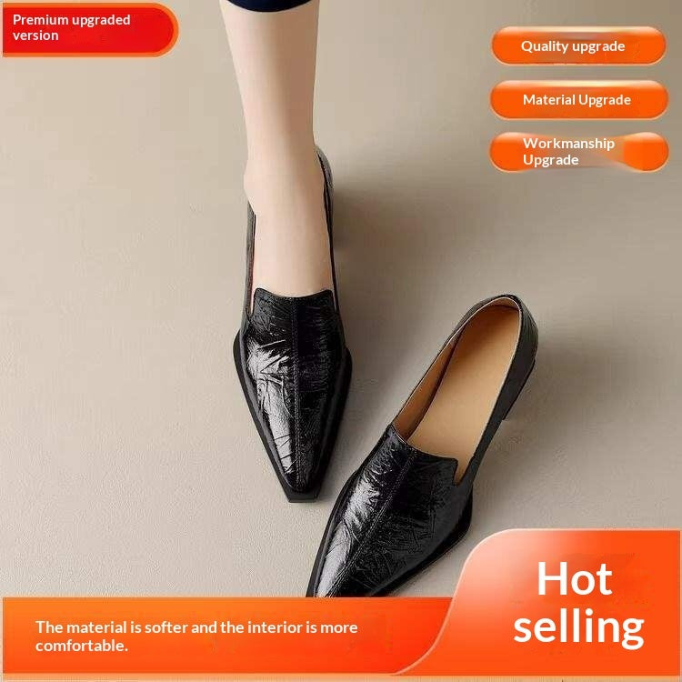 Black glossy leather slip-on women's flats with pointed toes, displayed on beige floor