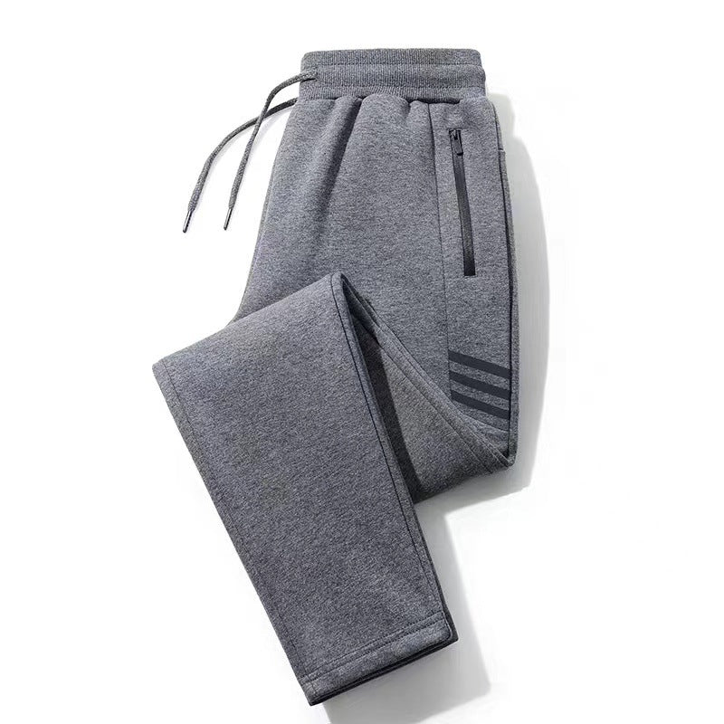 Gray athletic sweatpants with drawstring waist and zippered pocket, featuring three stripe detail