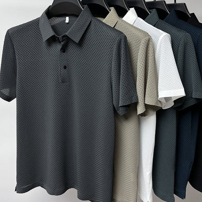 Six textured polo shirts in charcoal, beige, white, gray, navy, and black hung on black hangers