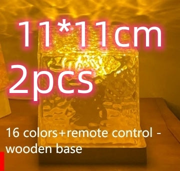 Decorative glass cube lamp on wooden base with warm yellow light and color options text