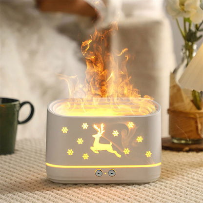 White essential oil diffuser with glowing reindeer and snowflake design emitting mist on a knitted surface
