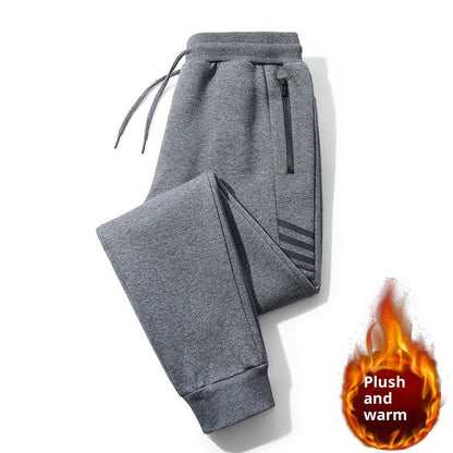 Folded grey plush warm jogger pants with zipper pocket and drawstring waist