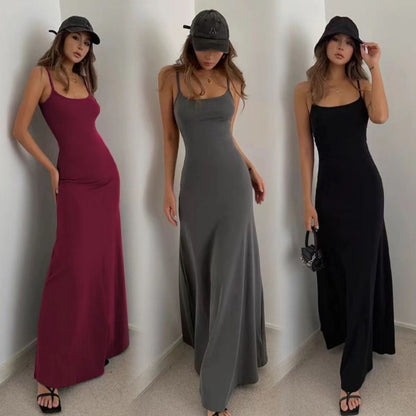 Three women modeling long sleeveless maxi dresses in burgundy, gray, and black with casual hats and sandals