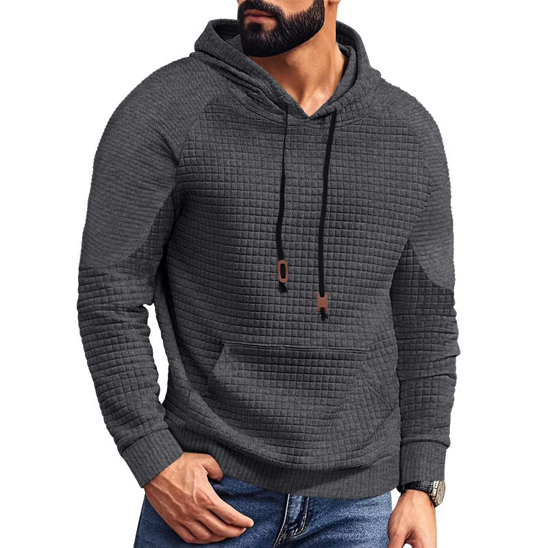 Man wearing dark gray textured hoodie with front pocket and black drawstrings