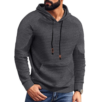 Man wearing dark gray textured hoodie with front pocket and black drawstrings