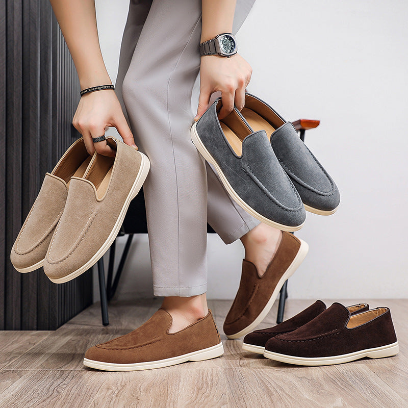 Person holding beige and dark gray slip-on casual shoes with brown and black pairs on floor