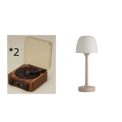 Wooden turntable record player with clear dust cover and beige modern table lamp