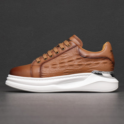 Brown leather sneaker with crocodile texture and white chunky sole on gray background