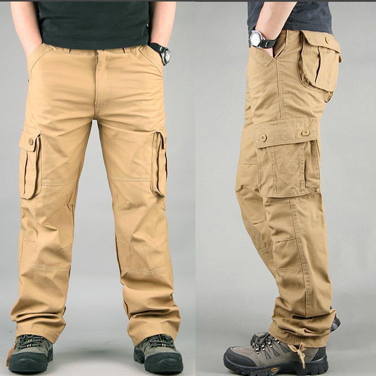 Men's tan cargo pants with buttoned side pockets worn with black shoes and black watch