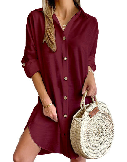 Woman wearing burgundy button-up shirt dress holding round woven straw handbag