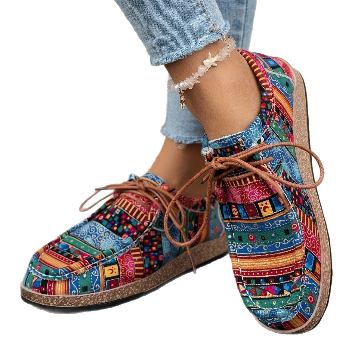 Colorful patterned casual lace-up shoes worn with cropped light blue jeans and a shell anklet