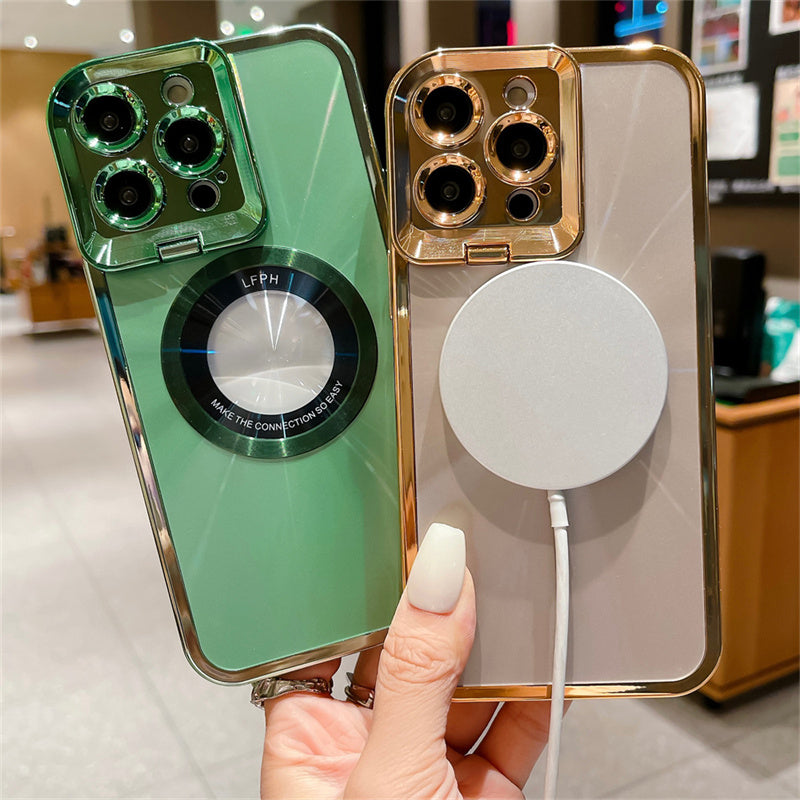 Hand holding two modern smartphones with green and gold cases, one with a magnetic charger attached