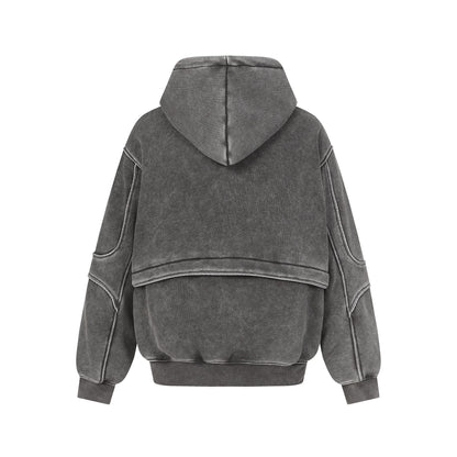 Back view of a gray washed oversized hoodie with stitched panel details and ribbed cuffs