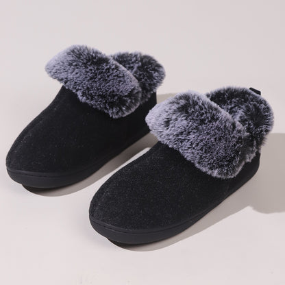 Black cozy indoor slippers with plush gray faux fur lining and trim on a light background