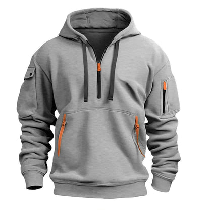 Light gray pullover hoodie with orange zipper accents and front and sleeve pockets
