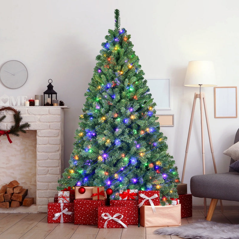 Decorated Christmas tree with multicolored lights and wrapped gifts under in cozy living room