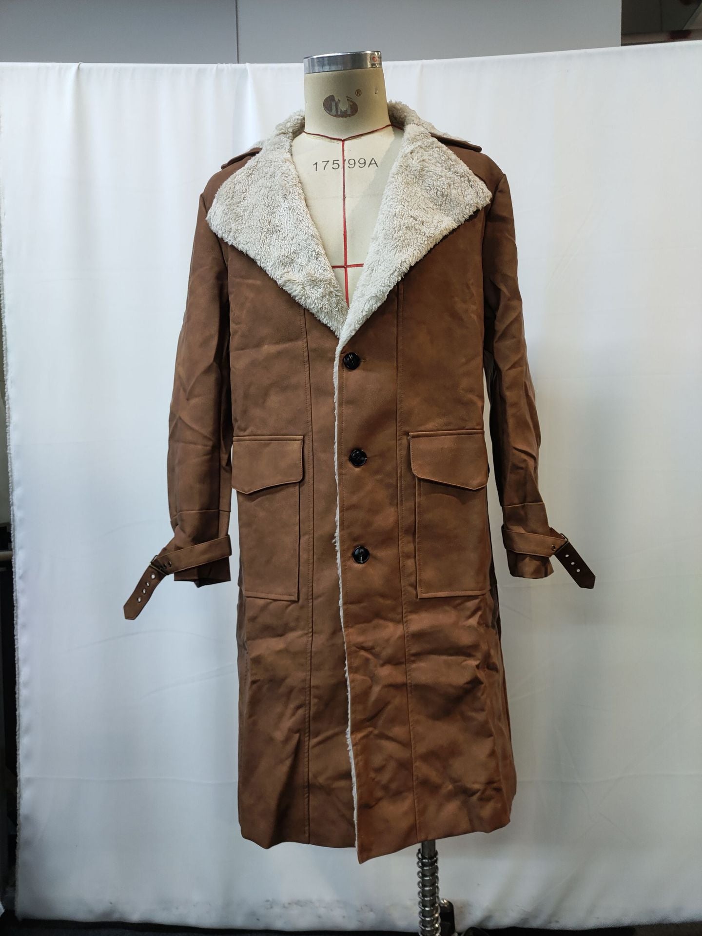 Brown suede long coat with white sherpa lining displayed on a dress form against a white backdrop