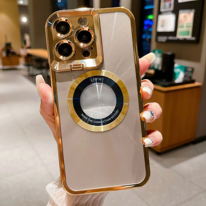 Hand holding smartphone with gold-trimmed beige case featuring circular magnetic ring and triple camera