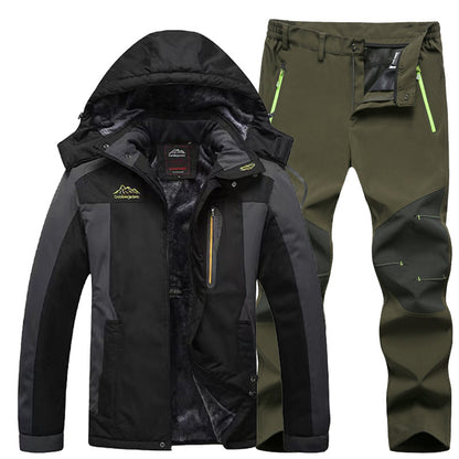 Black and gray outdoor jacket with hood and fleece lining paired with olive green hiking pants with reinforced knee patches