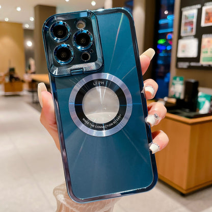 Hand holding blue smartphone with camera lenses and circular metal ring case in cozy indoor cafe