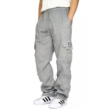 Person wearing gray cargo jogger pants with drawstring waist and white Adidas sneakers