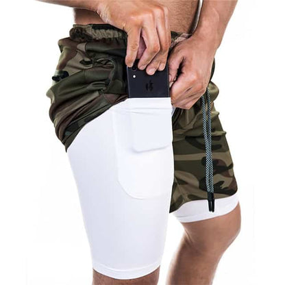 Man wearing camouflage shorts with built-in white compression pocket holding a smartphone