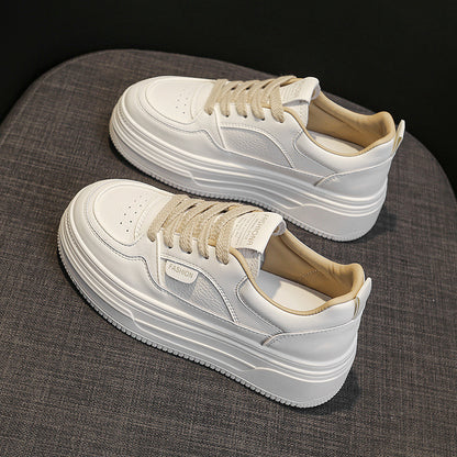 White platform sneakers with beige laces on gray fabric surface, featuring FASHION tag